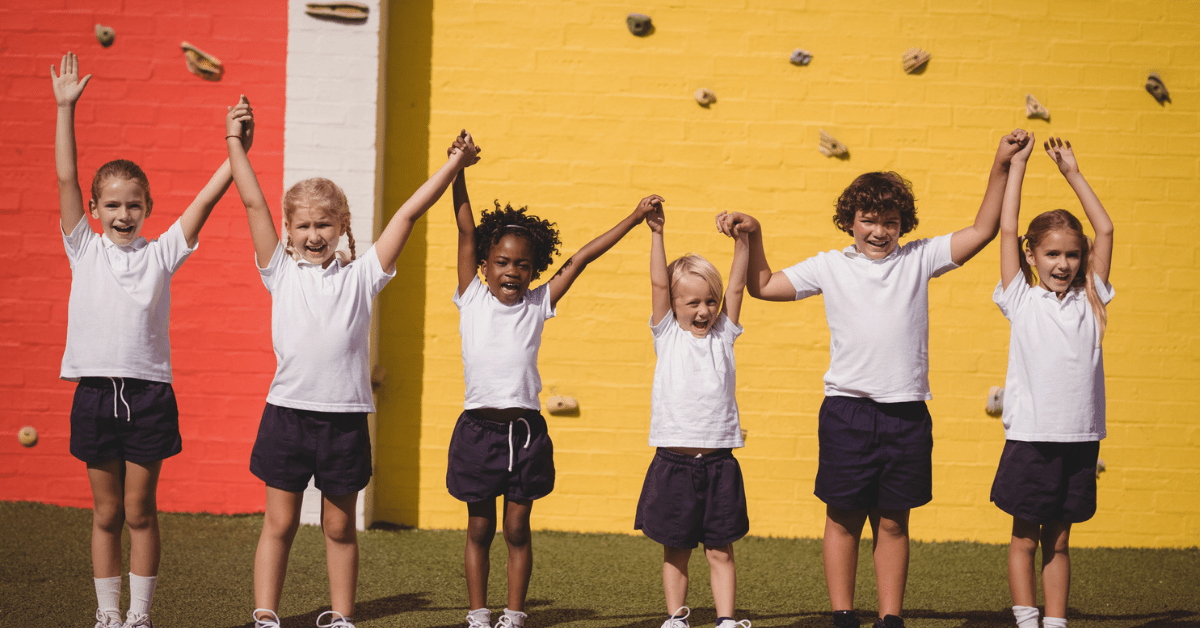 Young children in PE uniform cheering